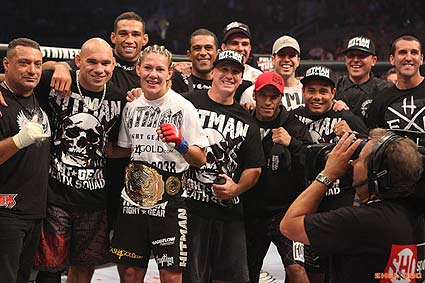 Christiane Cyborg Santos celebrates with her team after defeating Gina Carano to win the inaugural Strikeforce 145 pound women's title
